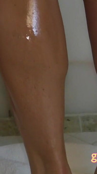 Busty bikini MILFS get oiled up together in the shower