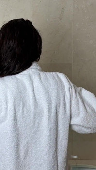 Mature Woman Takes off Her Clothes Except Her Bra in the Bathroom