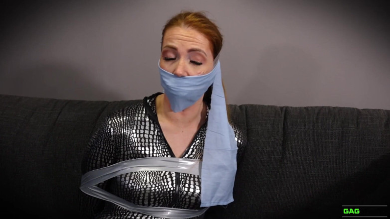 Gag Attack: Mila - Red head catsuit crook in tape bondage