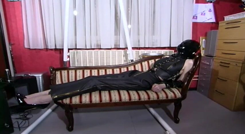 Fetish Desire: Masked leather chick posing on the couch