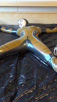 Latex Danielle is attached to the bed and masturbated with the massage vibrator