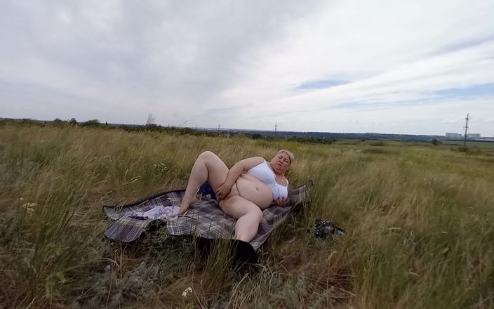 Sweet July: Fat woman masturbates pussy with a toy in the field