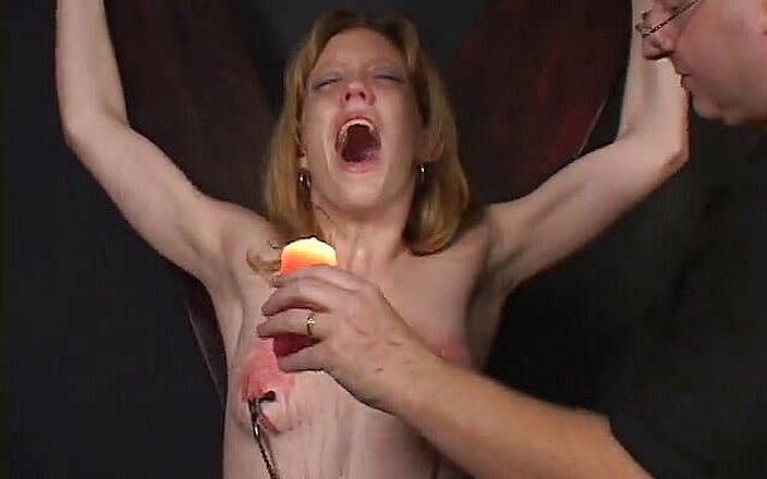 Dark Dungeon Secrets: Small tits whore collects wax on her tits
