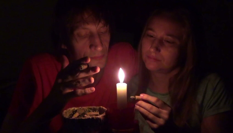 Sensual Lotuses: Couple Smoke Next to Candle
