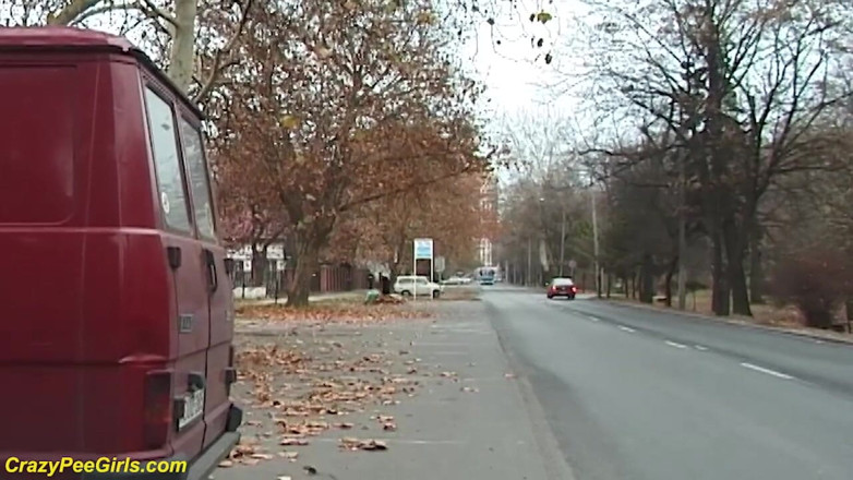Crazy pee girls: Girl peeing between the cars