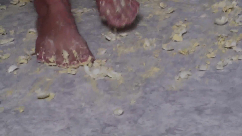 Foot Girls: Brunette crushing food in the kitchen