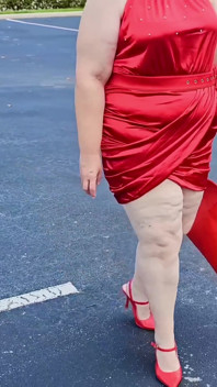 Hermosa mujer caminando al aire libre en el estacionamiento mostrando para extraños
