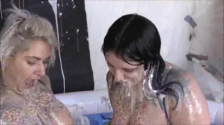 Gunked up girls: Tallulah sploshing food with her friend.