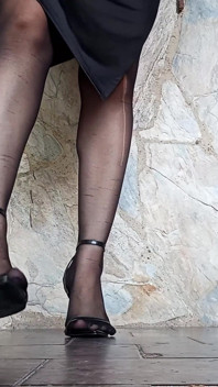 In Front of You the Secretary with Pantyhose and Stiletto Heels Dangling From Her Feet