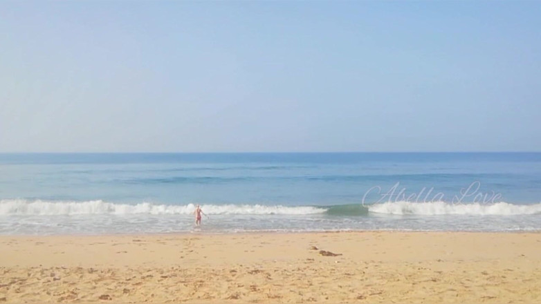 Abella Love: Slim MILF taking sun bath and peeing twice on beach
