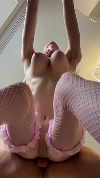 Slim Beauty with Massive Natural Tits in Pink Fishnet Stockings Teases Her Ass From Behind