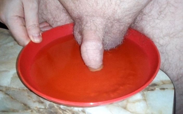 Sex hub male: John is peeing on a plate with the cock in...