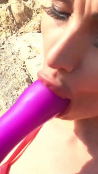 Alone lush Russian babe toys her cunt on the rock on the sea shore