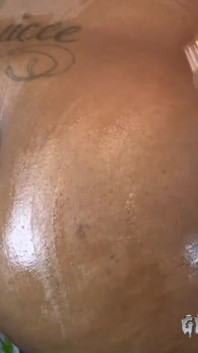Big booty ebony Jazzy drenches her massive black ass with oil