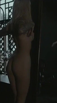 Tattooed teen is dancing in the dark room