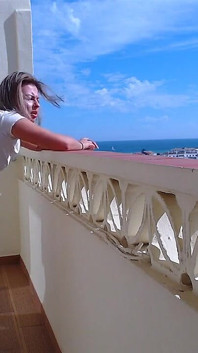 Geneukt en klaarkomen in haar poesje op het balkon terwijl fitte milf rookt