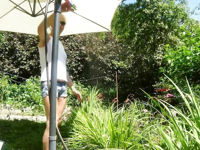 Alexa Cosmic Trans Girl Wetting & Wetlook in the Garden in White T-shirt and Denim Shorts Under Water From a Hose... (Alexa Cosmic)