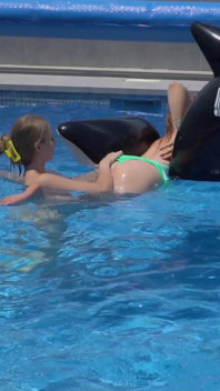 Lesbian Girls Are Having Fun in a Pool with an Inflatable Shark