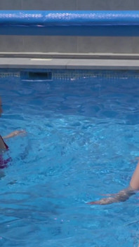 Lesbian Girls Are Having Fun in a Pool with an Inflatable Shark