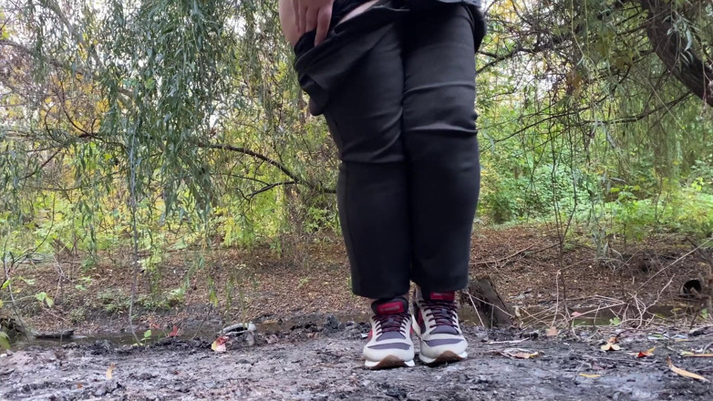 Elena: MILF dressed in pants pissing outdoors