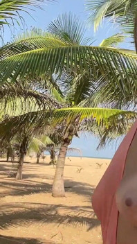 A Busty Blonde Woman Is Walking Around and Showing Her Naked Body on the Beach.