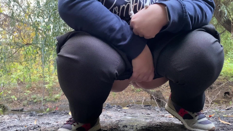 Elena: MILF dressed in pants pissing outdoors