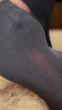 Jerks off his feet. Latex. Cum on legs