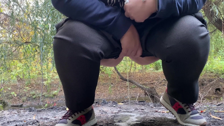 Elena: MILF dressed in pants pissing outdoors