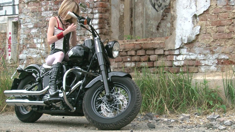 Public Entertainment: Skinny blonde on a bike