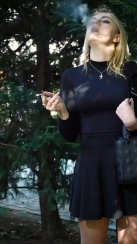 Hot Blonde Babe Smoking Two Black Cigarettes in Nature