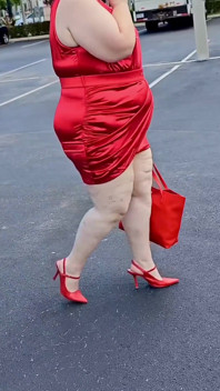 Hermosa mujer caminando al aire libre en el estacionamiento mostrando para extraños