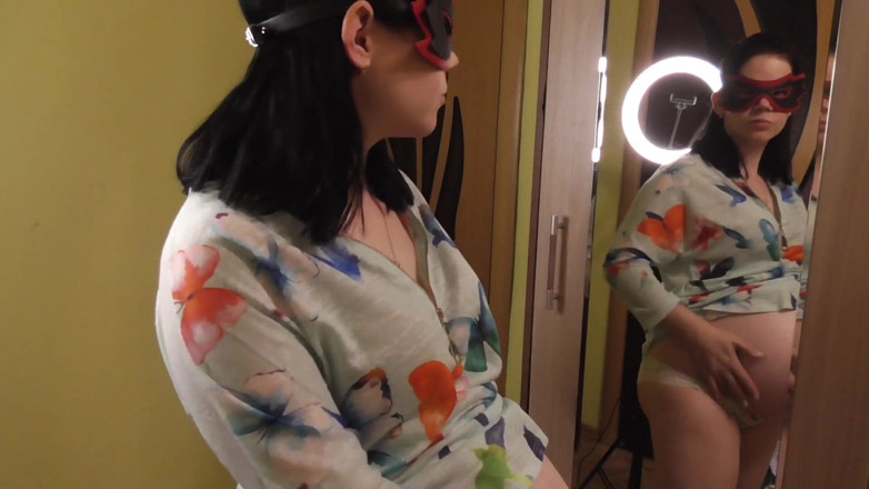 Anna Sky: Pregnant Anna trying on dresses in front of a mirror