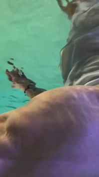 Amazon Kandy Flexes Her Massive Biceps in Her Hotel Pool