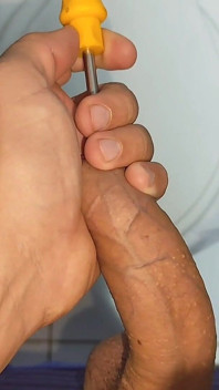 Young Straight Man Inserting the Tool Through the Glans.