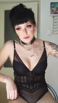 Tattooed gothic lady smoking in the kitchen