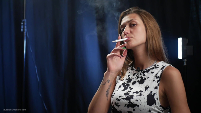 Russian Smokers: Confident Slim Brunette in a Tight Patterned Dress Enjoying a...