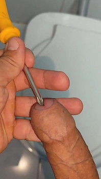 Young Straight Man Inserting the Tool Through the Glans.