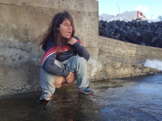 A Cute Expressiagirl in a Tracksuit Sat Down to Pee Near the Ocean (Pissing Everywhere)