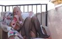 Gspot Productions: Outside on my balcony, wearing a black fishnet crotchless bodystocking,...