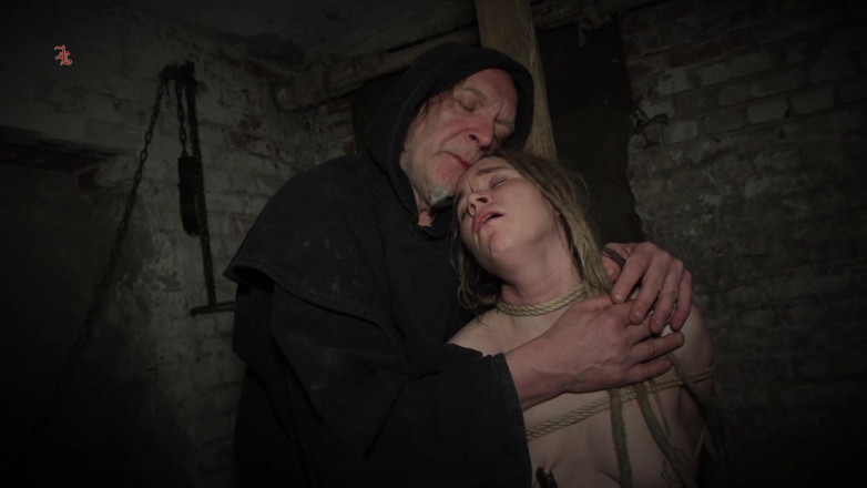 Inquisition and prison world: Clamps at the Body of a Tied up Moaning Witch
