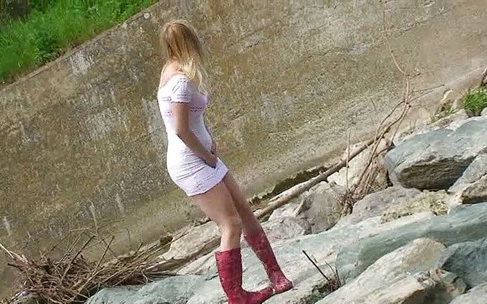 Femdom Austria: Blonde pissing outside in a river