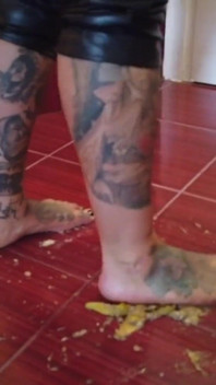 A banana is trampled by a blonde tattooed MILF