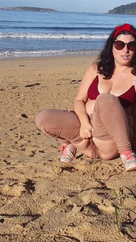 Woman Pissing on a Public Beach While No One Is There