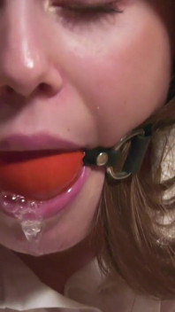 Leya is tied on a chair and drools through ballgag