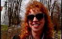 Lucky Cooch: Redhead lady wearing sunglasses while giving an interview