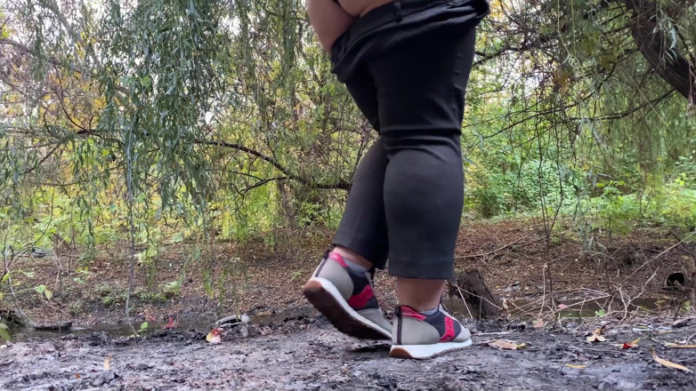 Elena: MILF dressed in pants pissing outdoors