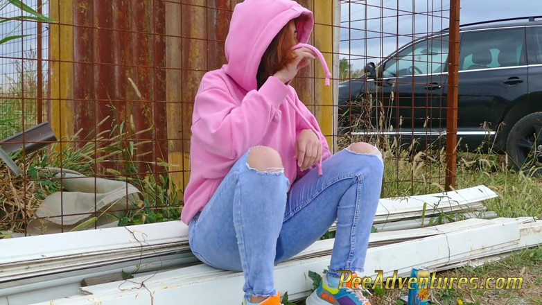 Pee Adventures: Girl with a hoodie pee trough her jeans