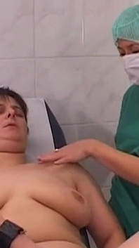 Mature Nurses Intimately Explore Patient on Exam Table