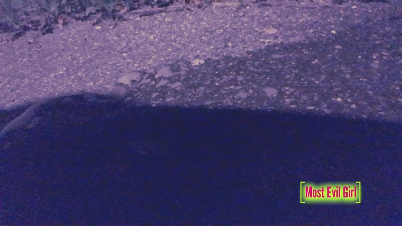 Most Evil Girl: Girl alone at night in a parking lot lowers her...