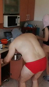 Couple Having Fun in the Kitchen. Sexy Wife Doing Chores in the House Naked